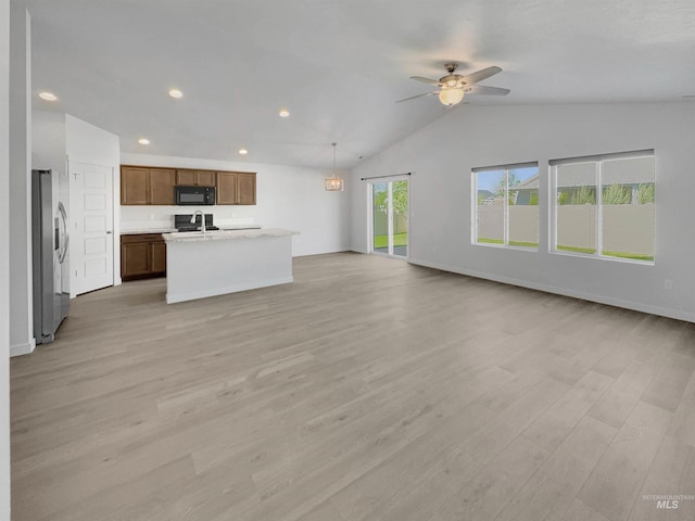 5394 N Elmstone Ave, Meridian, ID 83646 - unfurnished living room featuring a ceiling fan, light wood-type flooring, vaulted ceiling, baseboards, and recessed lighting