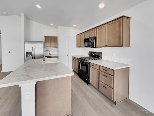 5394 N Elmstone Ave, Meridian, ID 83646 - kitchen featuring black appliances, a sink, lofted ceiling, light wood finished floors, and recessed lighting