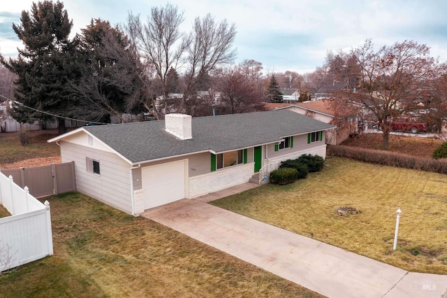 single story home with a garage and a front yard