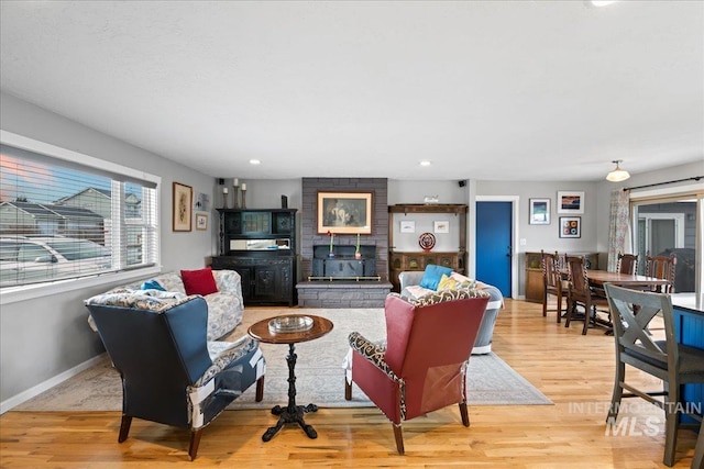 living room with recessed lighting, baseboards, and wood finished floors