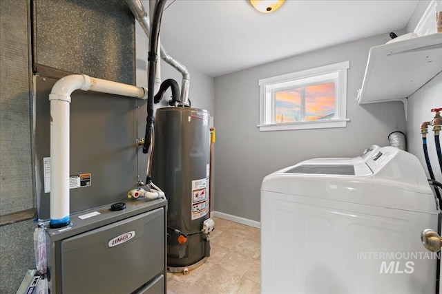 laundry area with laundry area, water heater, baseboards, and washing machine and clothes dryer