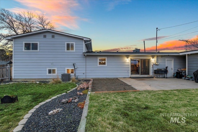 rear view of property featuring a patio, a yard, fence, and central air condition unit