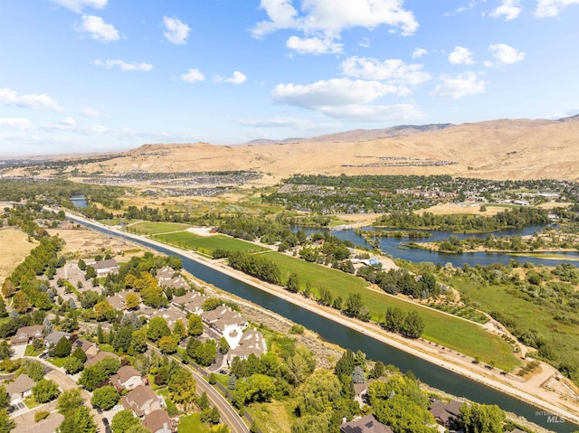 aerial view featuring a water and mountain view