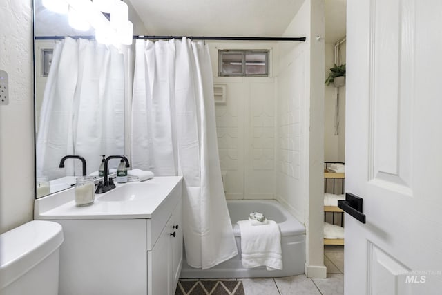 full bathroom featuring vanity, tile patterned floors, toilet, and shower / tub combo with curtain