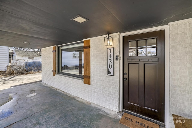 property entrance featuring brick siding