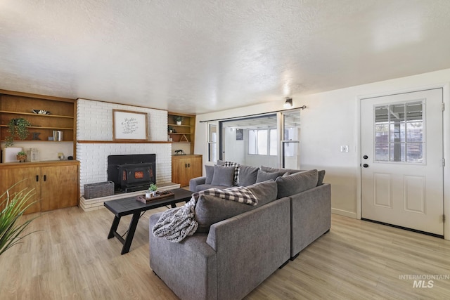 living area with light wood-type flooring and a textured ceiling