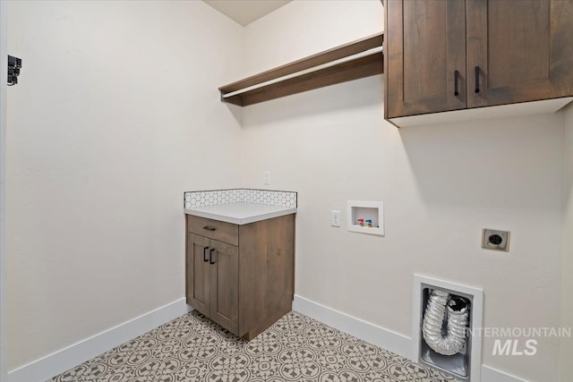 laundry area with baseboards, hookup for a washing machine, electric dryer hookup, and cabinet space