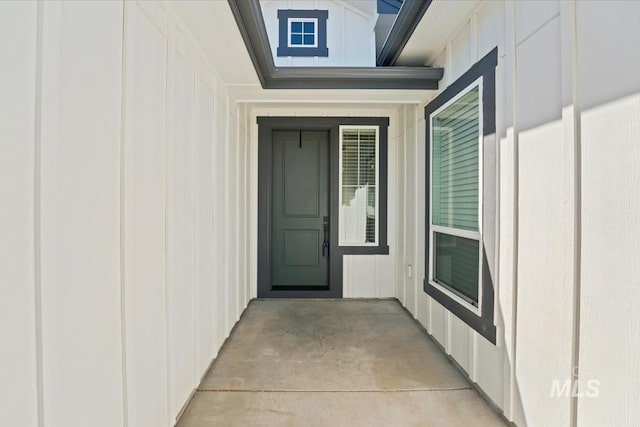 doorway to property featuring board and batten siding