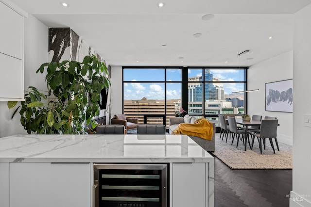 255 S Capitol Blvd Unit 1403, Boise, ID 83702 - kitchen featuring beverage cooler, expansive windows, white cabinets, light stone countertops, and recessed lighting