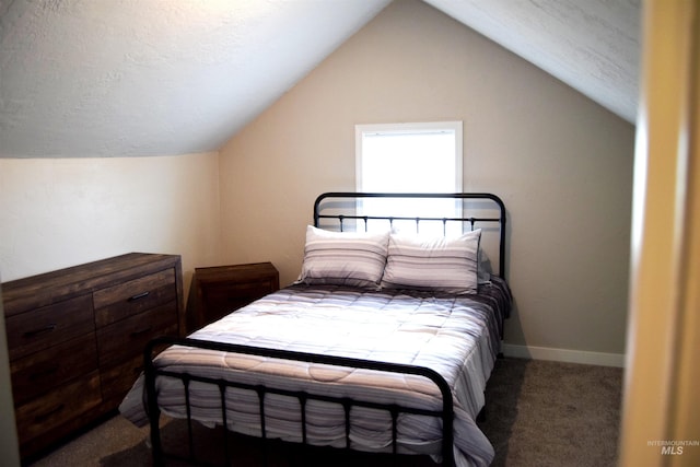 bedroom with a textured ceiling, lofted ceiling, and carpet