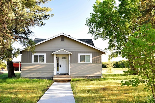 bungalow-style home featuring a shingled roof and board and batten siding
