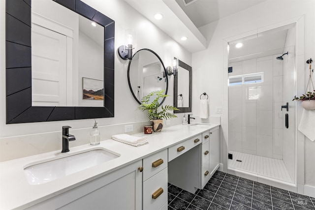 full bath featuring double vanity, tile patterned floors, a sink, and a stall shower