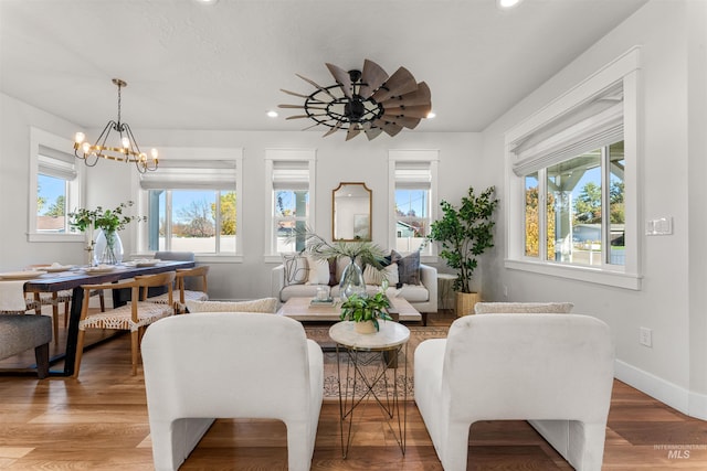 sitting room featuring a notable chandelier, baseboards, wood finished floors, and recessed lighting