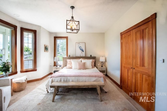 2350 Trail Rd, Moscow, ID 83843 - bedroom featuring baseboards, a chandelier, and light carpet