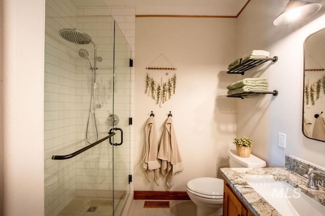 2350 Trail Rd, Moscow, ID 83843 - bathroom featuring toilet, vanity, a stall shower, crown molding, and baseboards