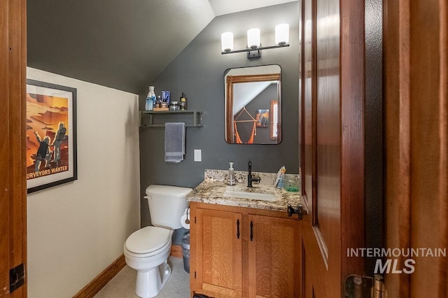 2350 Trail Rd, Moscow, ID 83843 - bathroom with toilet, vanity, lofted ceiling, and baseboards
