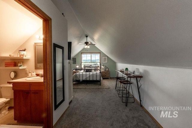2350 Trail Rd, Moscow, ID 83843 - carpeted bedroom featuring vaulted ceiling, a sink, and ensuite bathroom