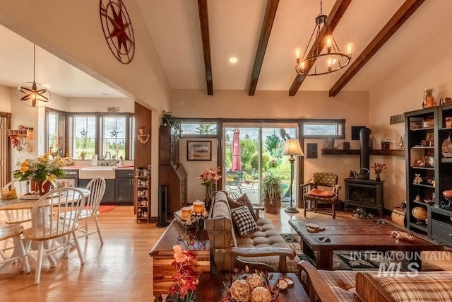 2350 Trail Rd, Moscow, ID 83843 - living room with a wood stove, light wood-style floors, and a chandelier