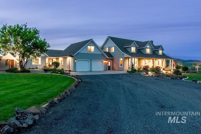 2350 Trail Rd, Moscow, ID 83843 - view of front facade featuring an attached garage, a front lawn, asphalt driveway, and a porch