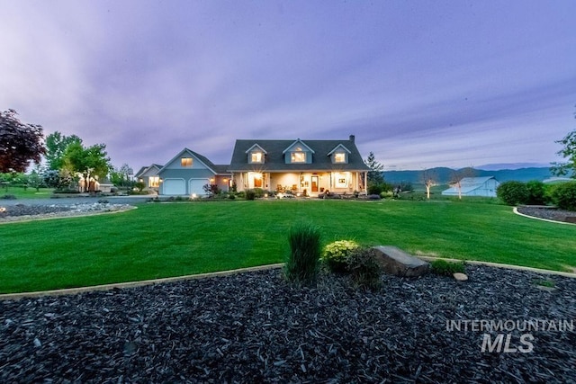 2350 Trail Rd, Moscow, ID 83843 - cape cod house featuring a front yard and a garage