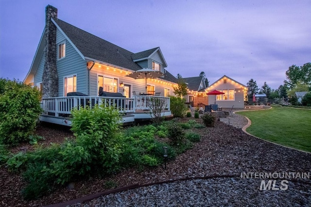 2350 Trail Rd, Moscow, ID 83843 - rear view of house with a deck, a yard, a chimney, and a patio area