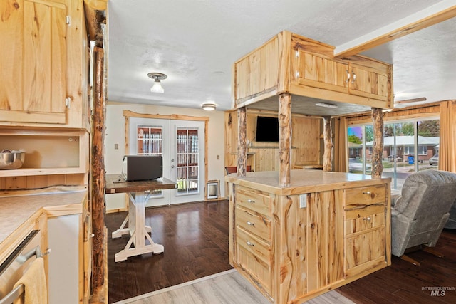 2074 11th Ave E, Twin Falls, ID 83301 - kitchen with french doors, wood finished floors, light brown cabinets, beamed ceiling, and a textured ceiling