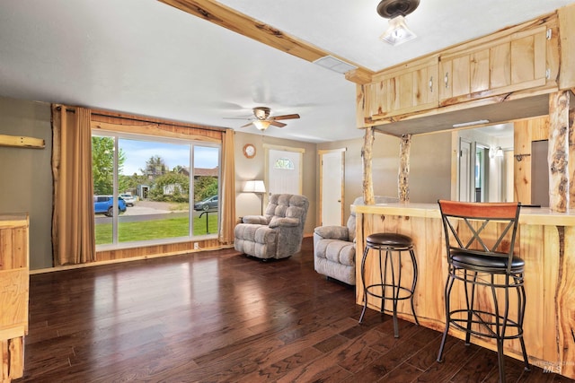 2074 11th Ave E, Twin Falls, ID 83301 - kitchen featuring dark wood-style floors, a ceiling fan, a breakfast bar, open floor plan, and light brown cabinets