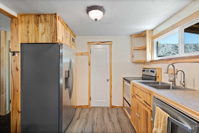 2074 11th Ave E, Twin Falls, ID 83301 - kitchen with stainless steel appliances, light wood-style floors, a sink, light countertops, and open shelves