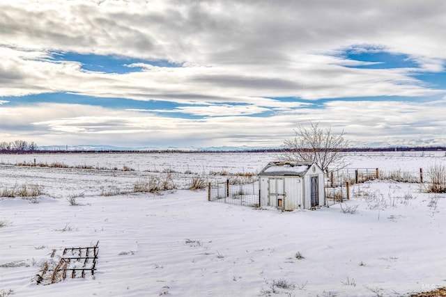 snowy yard featuring a rural view