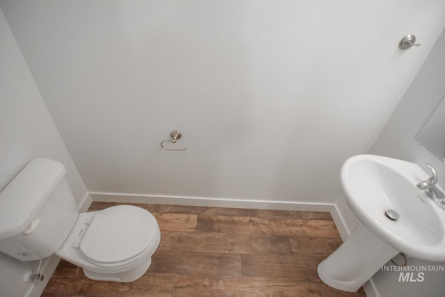 4044 W Ski Jump Ln, Meridian, ID 83642 - half bath with toilet, a sink, baseboards, and wood finished floors