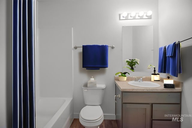 4044 W Ski Jump Ln, Meridian, ID 83642 - bathroom featuring vanity, toilet, baseboards, bathtub / shower combination, and wood finished floors