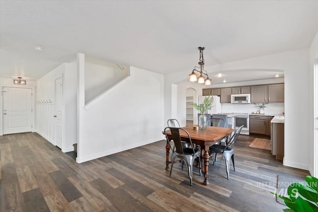 dining room with dark hardwood / wood-style flooring and a notable chandelier