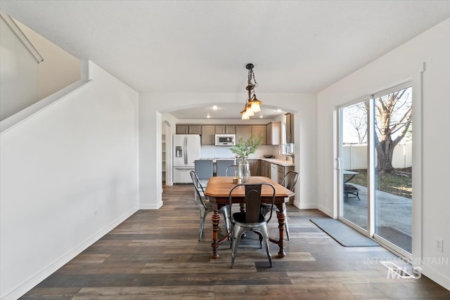 dining area featuring sink and dark hardwood / wood-style floors