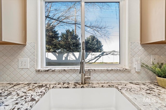 details featuring sink and light stone countertops