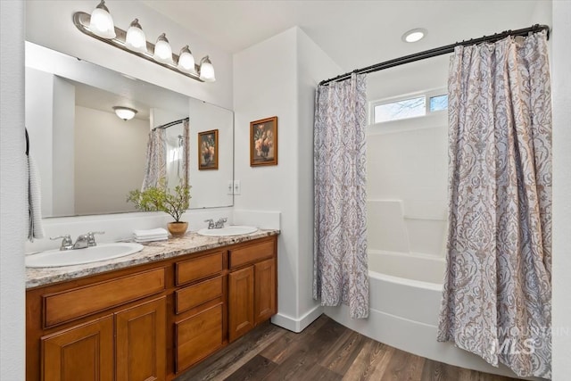 bathroom with shower / bathtub combination with curtain, vanity, and hardwood / wood-style flooring