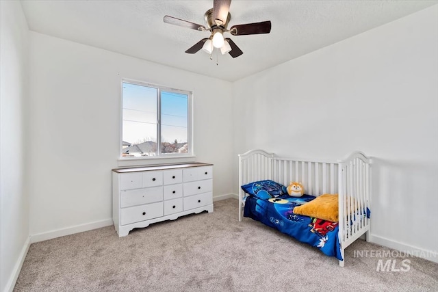 bedroom featuring light colored carpet and ceiling fan