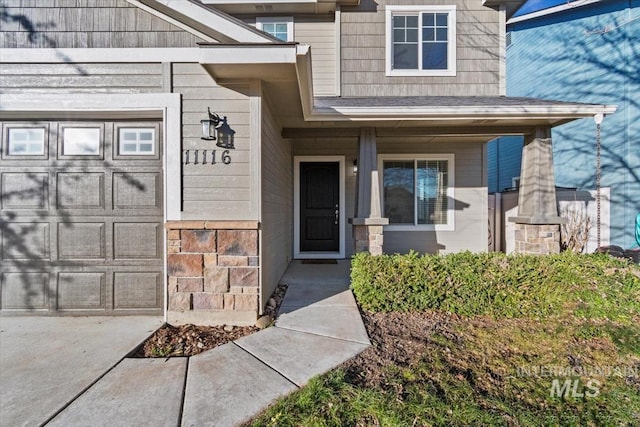 doorway to property with a garage