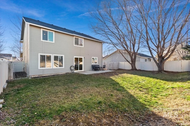 rear view of property featuring a patio area and a yard