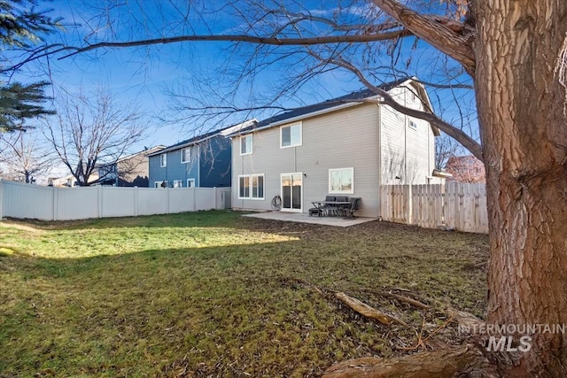 back of property with a patio and a yard