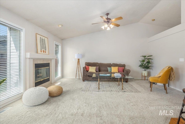 14325 W Comisky, Boise, ID 83713 - carpeted living room with lofted ceiling, ceiling fan, and a tile fireplace