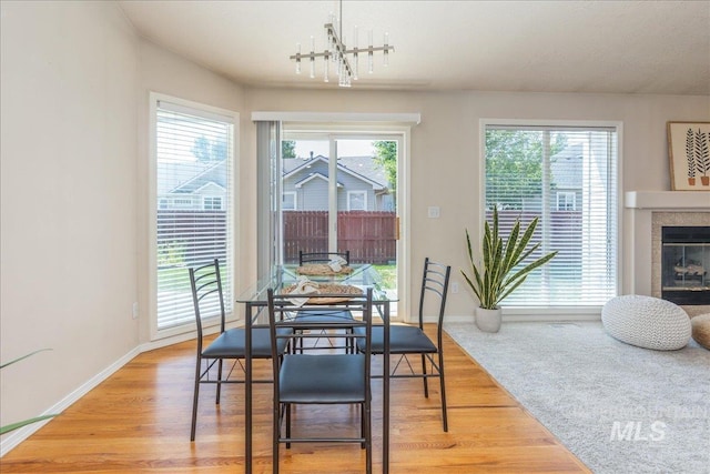 14325 W Comisky, Boise, ID 83713 - dining area featuring wood finished floors, a chandelier, and a fireplace