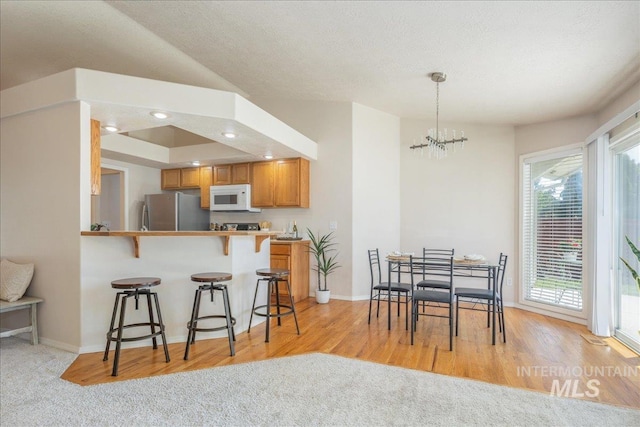 14325 W Comisky, Boise, ID 83713 - dining room featuring a chandelier, light wood-type flooring, and recessed lighting
