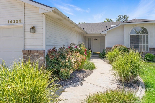 14325 W Comisky, Boise, ID 83713 - property entrance featuring an attached garage and stone siding