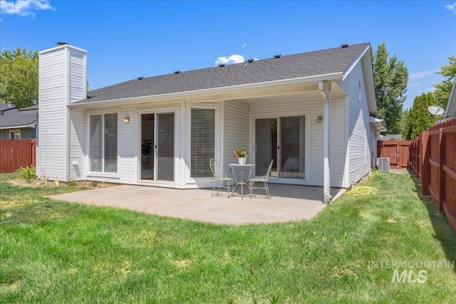 14325 W Comisky, Boise, ID 83713 - back of property with a patio area, a fenced backyard, a chimney, and a shingled roof