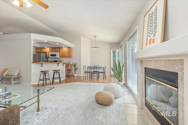 14325 W Comisky, Boise, ID 83713 - living area with lofted ceiling, ceiling fan, light wood-type flooring, a tile fireplace, and recessed lighting