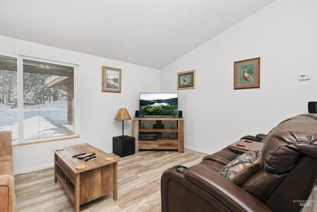 living room featuring light wood-type flooring and vaulted ceiling