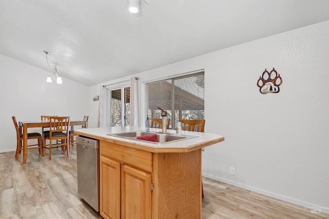 kitchen with dishwasher, an island with sink, pendant lighting, sink, and lofted ceiling