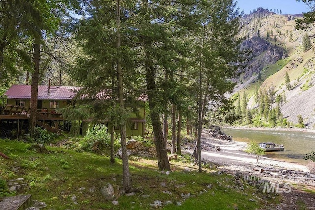 view of yard with a deck with mountain view