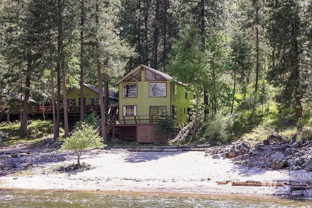 view of front of house with a deck with water view