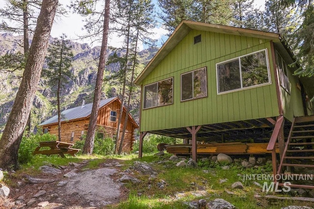 view of property exterior with a mountain view